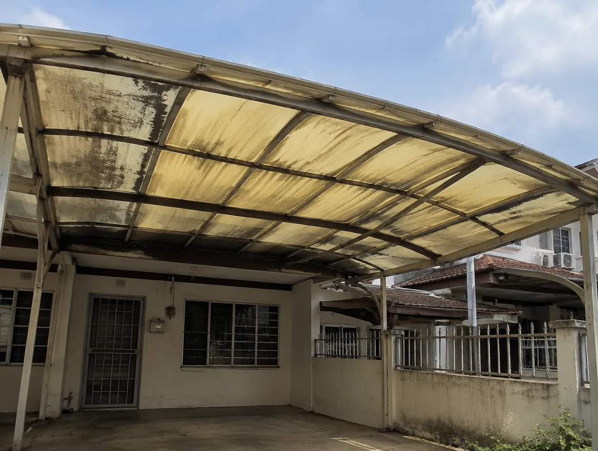 Yellowed and hazy polycarbonate awning over a Malaysian terrace house car porch